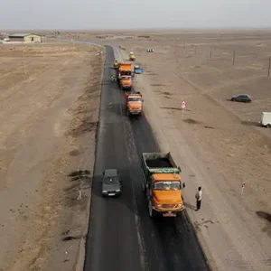 تصویر هوایی سه کامیون نارنجی آسفالت