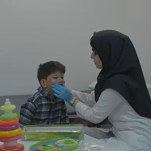 پرستار بخش درحال گفتار درمانی با کودک