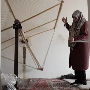 نمای از کار با دستگاه بافندگی دستی در روستا